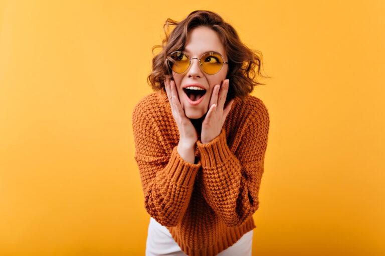 inspired white female model vintage sunglasses looking away with surprised smile