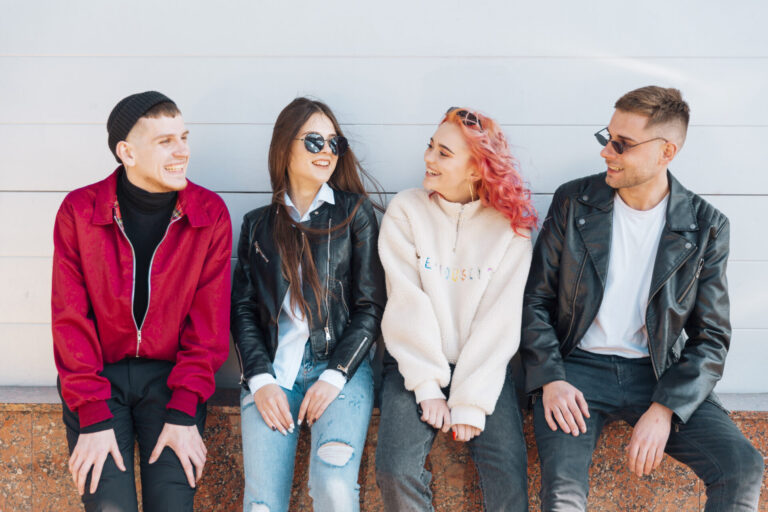young friends smiling looking each other